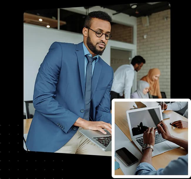 Travel professionals working together with laptops in an office